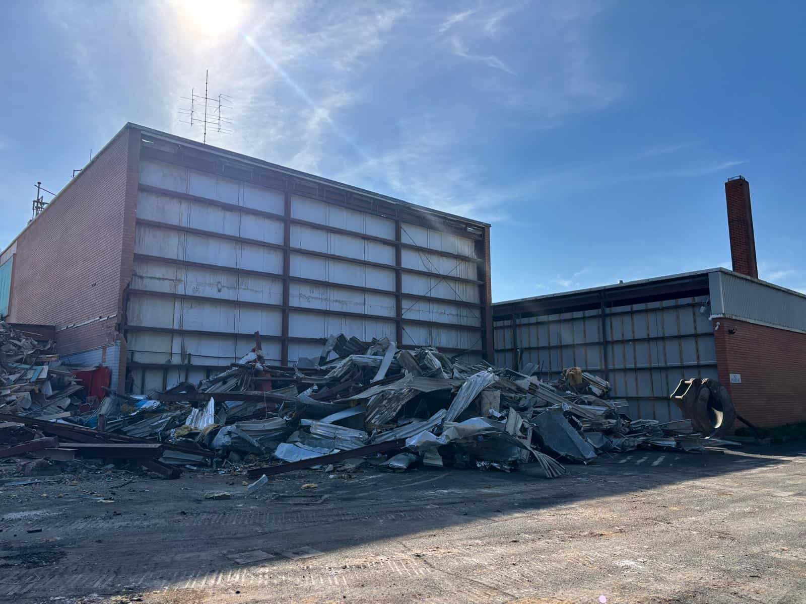 Former WIN Television studio buildings after soft strip and salvage, with stripped material stockpiled for removal, Ballarat North