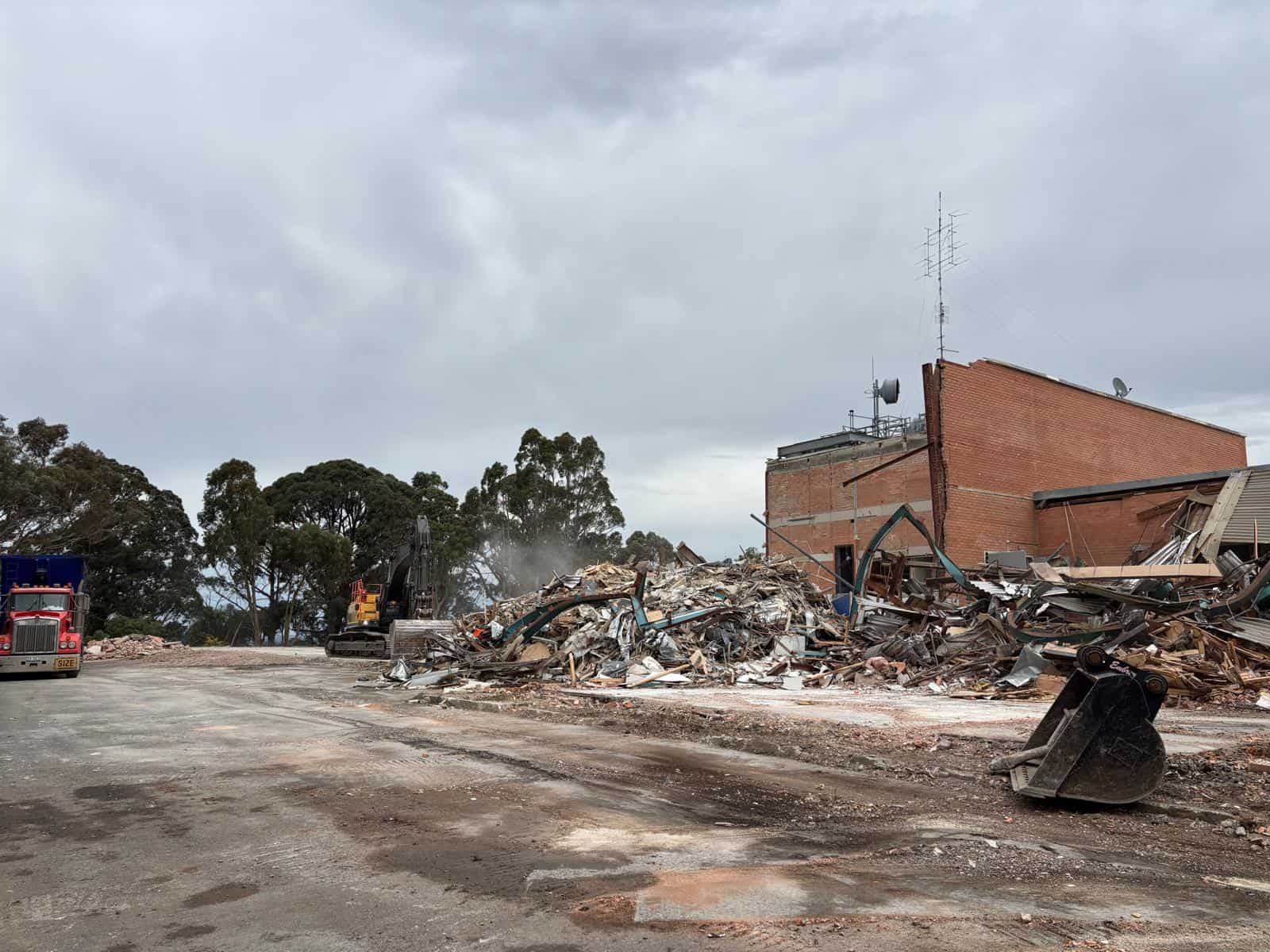 Excavator demolition of the WIN Television studio buildings at 207 Walker St, Ballarat North, with debris separated for recycling